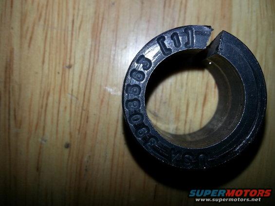 Black circular part with numbers 0-8565 and [1] stamped on it
