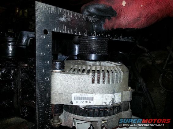 Alternator with a ruler measuring its pulley, showing part number 45.07.263.01