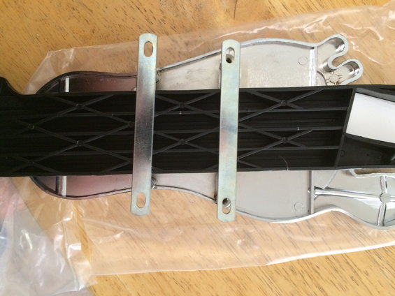 Close-up of a black strap with metal buckles, possibly from a seatbelt or cargo restraint