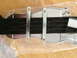 1964 Ford Ranchero - Detail of a black strap and metal buckles, likely an interior car component.