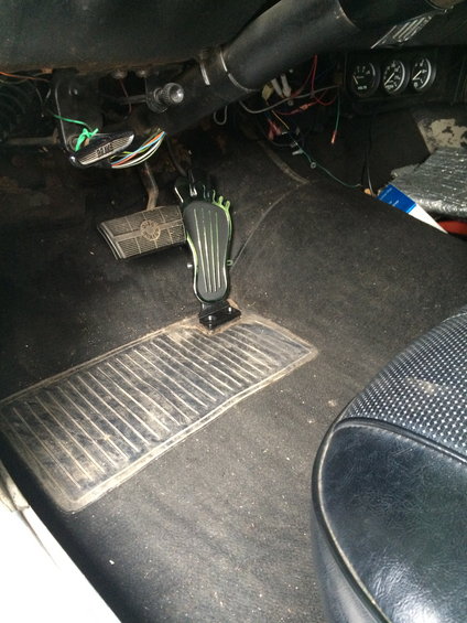 Car interior with brake and accelerator pedals visible