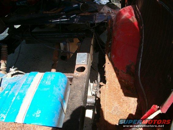 Blue fuel tank with white stripes and rusty frame