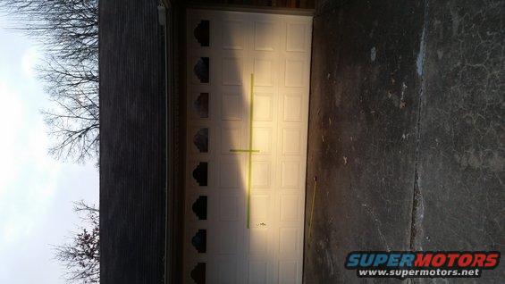 White garage door with a yellow tape line across it