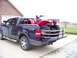 1984 Honda ATC 250 R - A red ATV is transported in the bed of a blue pickup truck.