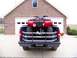 1984 Honda ATC 250 R - A red ATV is loaded into the bed of a dark blue pickup truck, viewed from the rear.