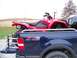 1984 Honda ATC 250 R - A red Honda ATV is secured in the bed of a blue pickup truck, ready for transport.