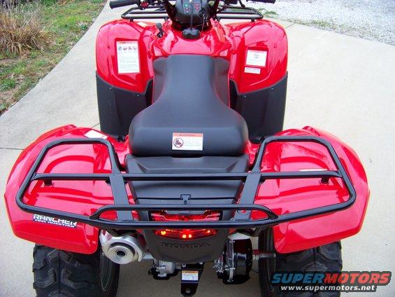 Red ATV rear view with black racks and a Honda logo