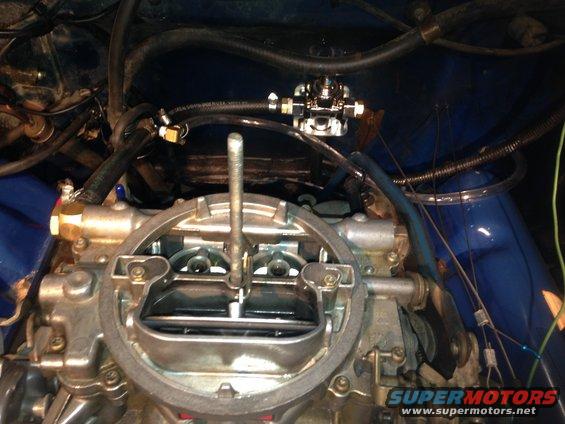 Engine bay with carburetor and fuel pump. Visible text: SUPERMOTORS www.supermotors.net