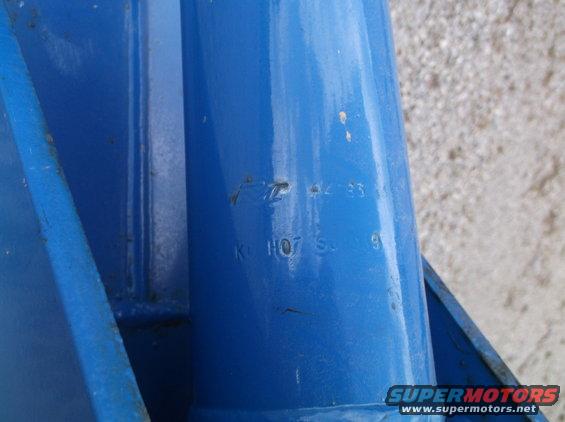Blue metal part with stamped numbers '42-33' and '1107 S 9'