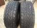 1986 Ford Bronco - A close-up view of two Bridgestone Dueler tires, showing their tread pattern.