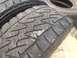 1986 Ford Bronco - A close-up view of tire treads, with another tire stacked behind it.
