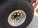1986 Ford Bronco - A close-up view of a tire and wheel assembly, with visible text on the tire and a Supermotors.net watermark.