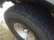 1986 Ford Bronco - Close-up of a tire and wheel with a SuperMotors logo visible on the tire.
