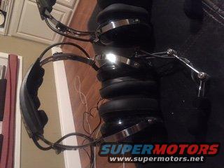 Two pairs of black headphones with chrome accents and adjustable booms