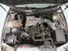 1999 Ford Fairlane - The engine bay of a vehicle is shown with the hood open, revealing the engine components and V6 4.0L badging.