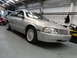 1999 Ford Fairlane - A silver sedan is parked in a garage, with another vehicle partially visible on the left.