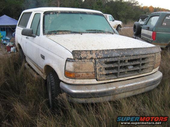 1994 Ford Bronco front 3/4 view, covered in mud