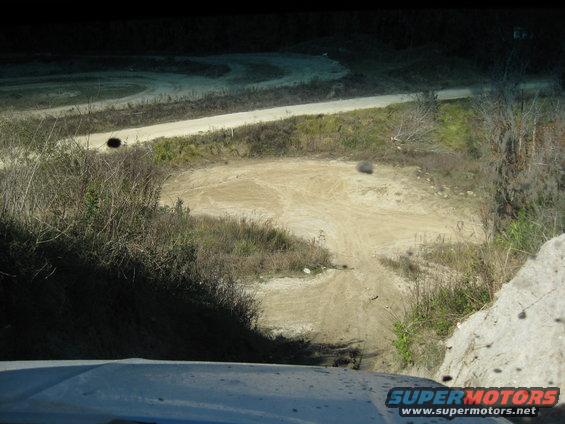 Dirt track with turns and hills, seen from a vehicle
