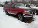 1990 Ford Bronco - This red Ford F-150 pickup truck with a camper shell is parked in the snow next to another truck.