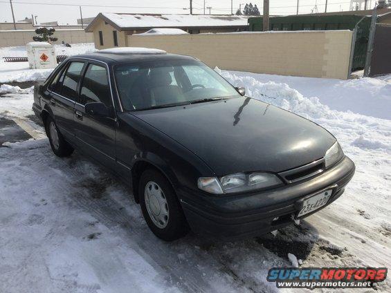 1995 Holden Astra sedan parked on snowy ground, front quarter view