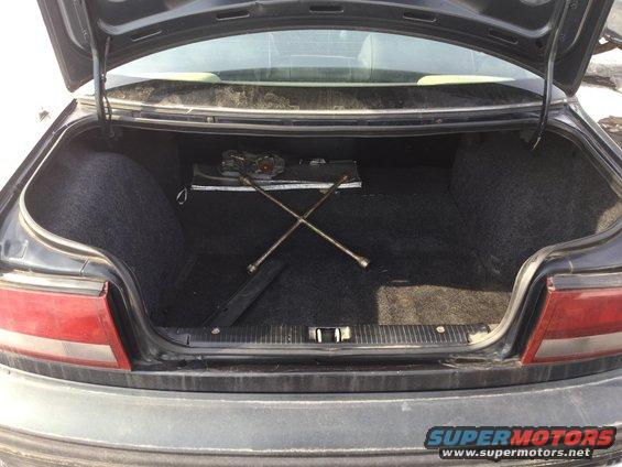 Car trunk interior with spare tire tools and jack