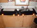 1990 Ford Bronco - A black visor with amber marker lights is shown installed above a kitchen sink and cabinets.