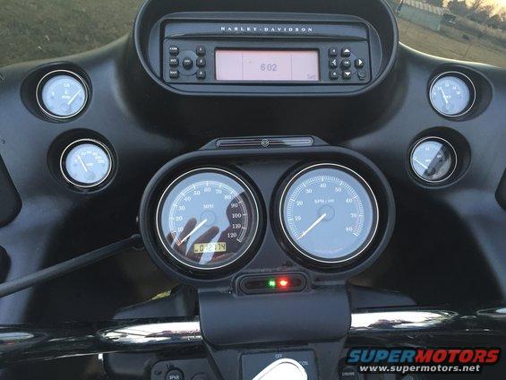 Motorcycle dashboard with Harley-Davidson radio and dual gauges