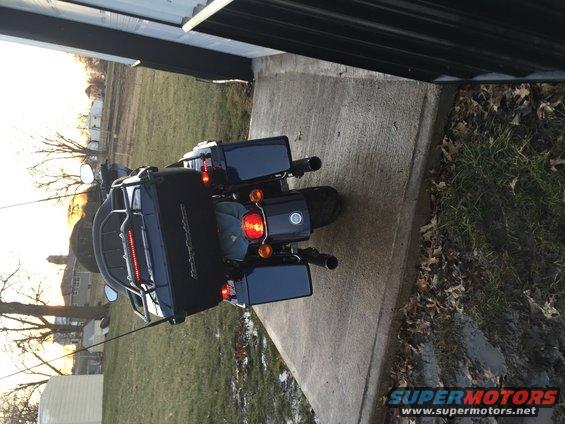 2013 Harley-Davidson FLHX parked on concrete, rear view. Black saddlebags and tour pack