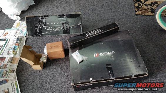 Boxes of Axiom tail lights and Junyan LED brake light for 99-04 Mustang