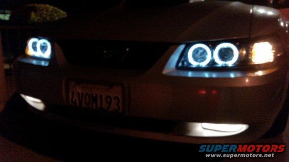 Front view of a 2002 Ford Mustang with custom halo headlights and a California license plate