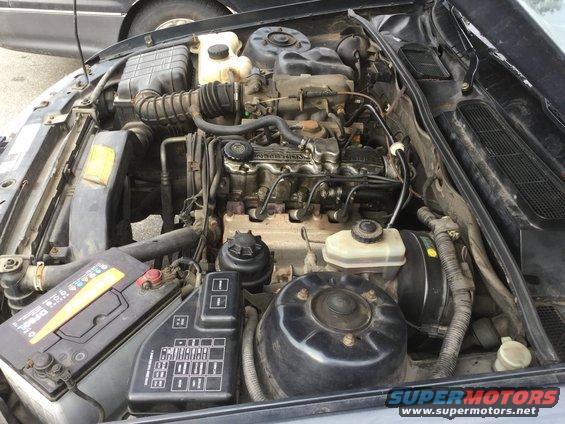 Engine bay with battery and fuse box visible