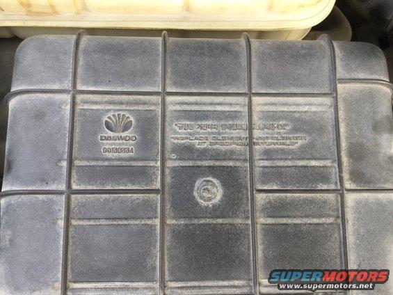 Daewoo logo and part number 96130884 on a black plastic air cleaner housing. Text reads 'REPLACE ELEMENT AND CLEANER AT SPECIFIED INTERVALS'