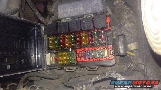 Car fuse box with relays and fuses. Some fuses are labeled with amperage
