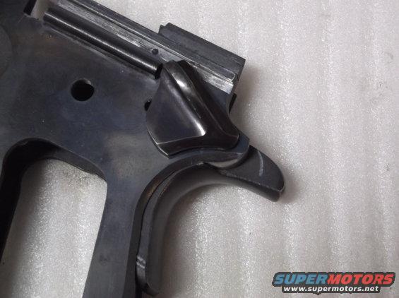 Close-up of a gun's metal frame and trigger mechanism