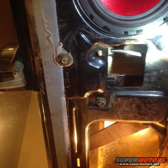 Close-up of a car's interior door mechanism with a red speaker visible