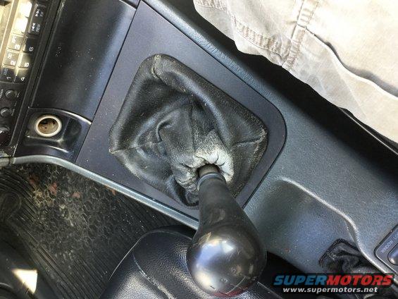 Interior view of a manual gear shifter with a leather boot