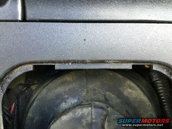 Close-up of a car headlight housing with some dust and debris