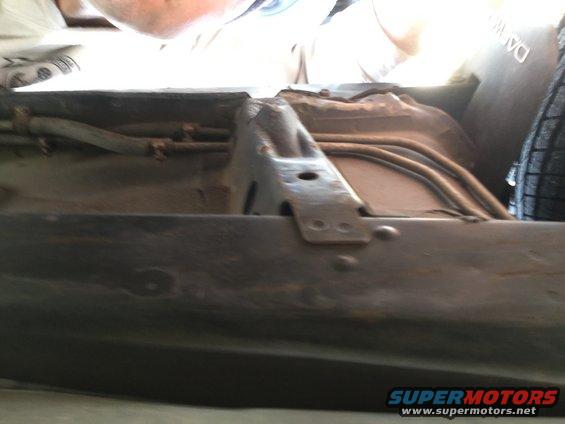 underbody of a car with fuel lines and some structural components visible