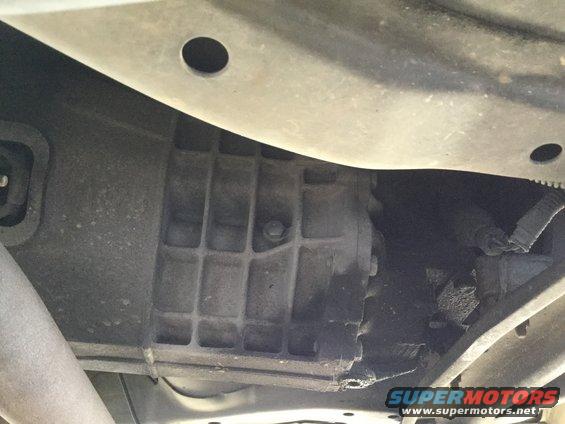 Transmission housing with ribbed texture, viewed from below. Some grease visible