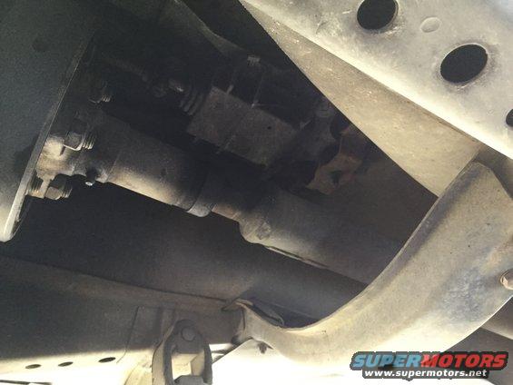 underside of a vehicle showing driveshaft and frame components