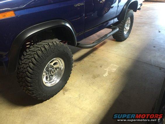 1982 Ford Bronco side view showing off-road tires, side steps, and blue paint