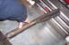 1990 Ford Bronco - A person is holding a worn slider gasket, likely a replacement part for a vehicle.