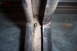 1990 Ford Bronco - Detail of a slider gasket, showing wear and a screw hole, likely from a vehicle door or window assembly.