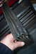 1990 Ford Bronco - A hand holds a damaged rubber seal, likely for a vehicle window or door.