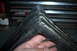 1990 Ford Bronco - Close-up of a worn rubber gasket corner, possibly for a vehicle component.