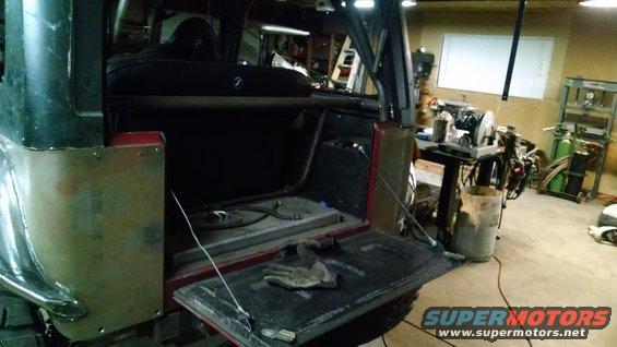 1985 Jeep CJ7 interior with tailgate open, showing roll cage and work area