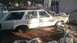 1980 Ford Fairmont - A white 1980 Ford Fairmont station wagon sits in a yard, appearing weathered and unused.