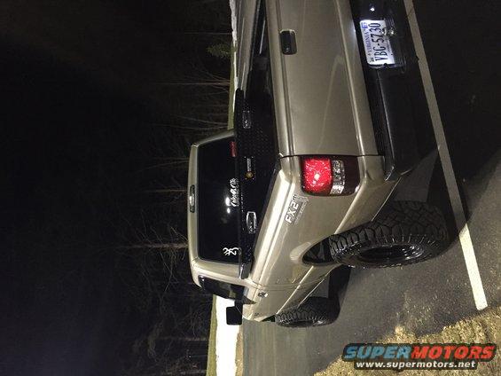 Tan pickup truck rear view with FX2 badging and Virginia license plate VBG-5730