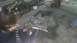 2000 Chevrolet Astro - A person uses an angle grinder on a section of vehicle frame in a workshop setting.