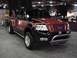 1995 Ford Bronco - This modified Ford F-150 pickup truck is displayed indoors, possibly at a car show.